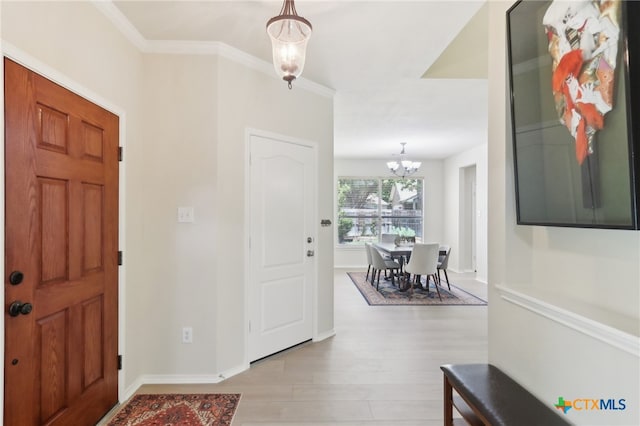 19303 Anna Kate Ct, Pflugerville, TX 78660 - entryway with light wood-style floors, a chandelier, crown molding, and baseboards