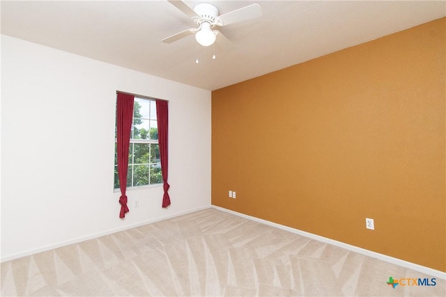 2409 Eppinette Dr, Killeen, TX 76542 - empty room featuring light carpet, a ceiling fan, and baseboards