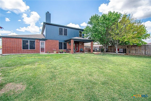 2409 Eppinette Dr, Killeen, TX 76542 - rear view of house featuring brick siding and a chimney