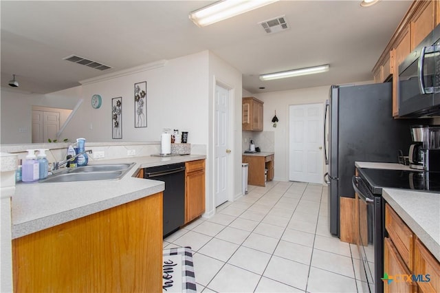 2409 Eppinette Dr, Killeen, TX 76542 - kitchen featuring black appliances, a sink, light tile patterned flooring, and brown cabinetry