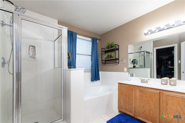 2409 Eppinette Dr, Killeen, TX 76542 - full bathroom featuring a shower stall, a bath, double vanity, a walk in closet, and tile patterned flooring