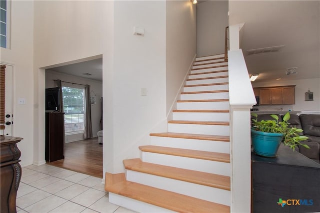2409 Eppinette Dr, Killeen, TX 76542 - stairs with tile patterned flooring and a high ceiling