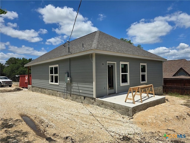 1420 Canyon Bnd, Canyon Lake, TX 78133 - rear view of property featuring a shingled roof and a patio area