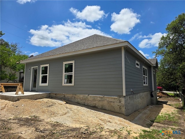 1420 Canyon Bnd, Canyon Lake, TX 78133 - view of side of property featuring roof with shingles and a patio area
