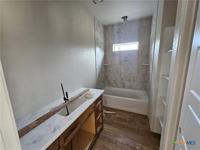 1420 Canyon Bnd, Canyon Lake, TX 78133 - full bathroom featuring vanity, a textured wall, shower / bathtub combination, and wood finished floors