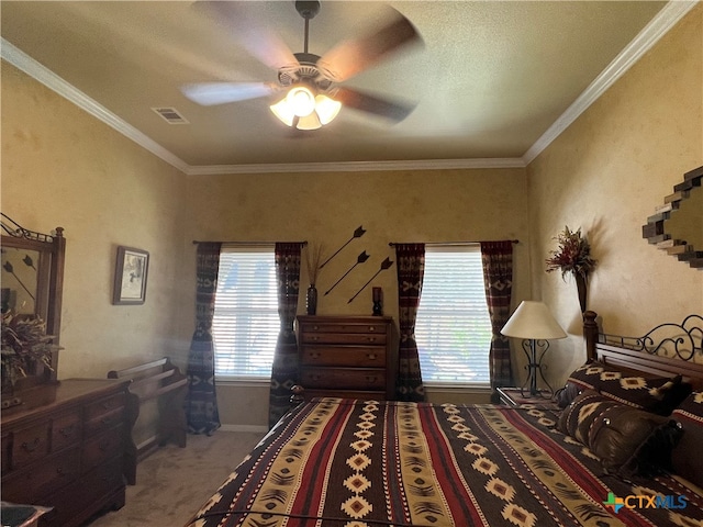 carpeted bedroom with ceiling fan, a textured ceiling, and crown molding