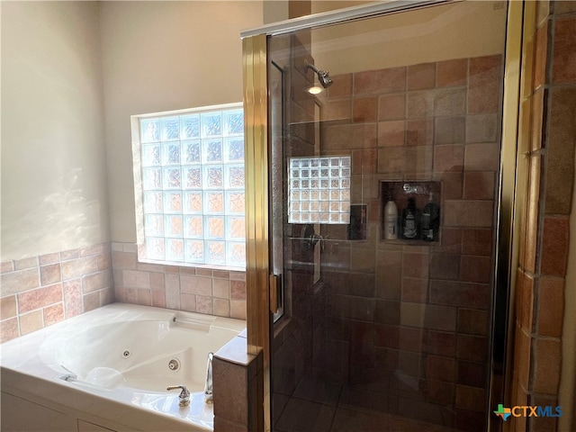 bathroom with separate shower and tub