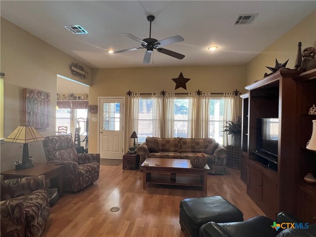 living room featuring hardwood / wood-style floors and ceiling fan