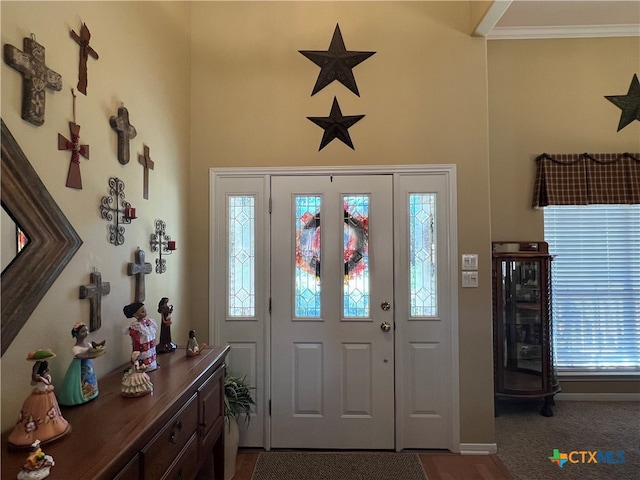 entrance foyer featuring ornamental molding