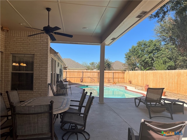 view of patio / terrace with ceiling fan and a fenced in pool