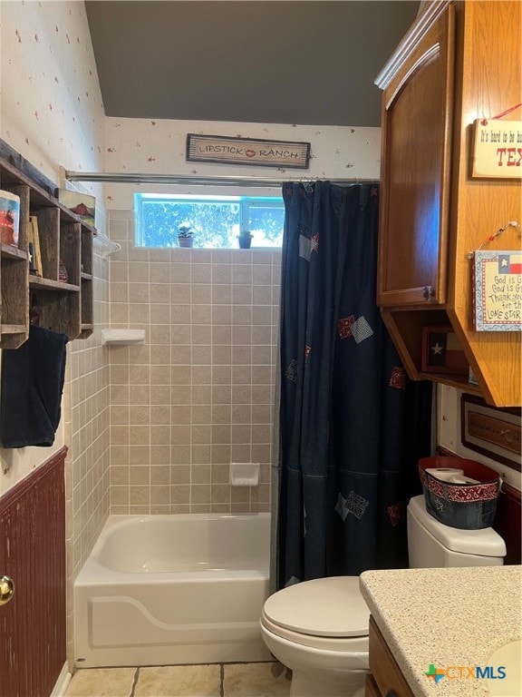 full bathroom featuring toilet, vanity, tile patterned floors, and shower / tub combo with curtain