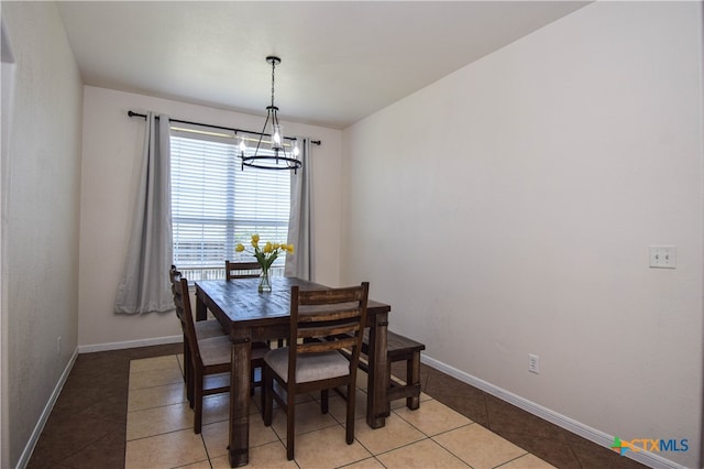 dining area featuring a chandelier and light tile patterned floors