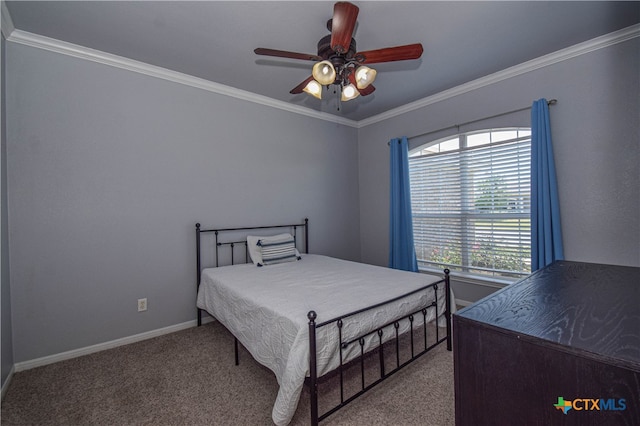 carpeted bedroom featuring ceiling fan and crown molding