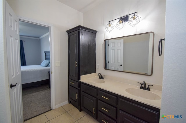 bathroom with ornamental molding, tile patterned flooring, and vanity