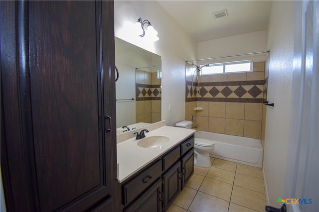 full bathroom with vanity, tile patterned floors, toilet, and tiled shower / bath combo