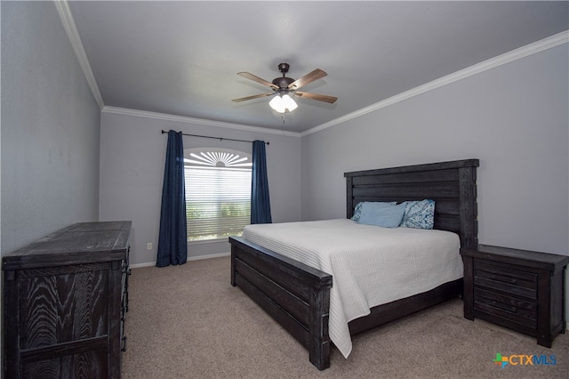 carpeted bedroom featuring ceiling fan and crown molding