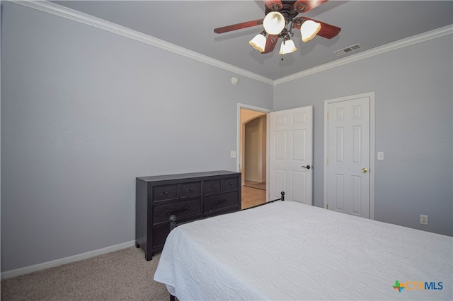 carpeted bedroom featuring ceiling fan and crown molding