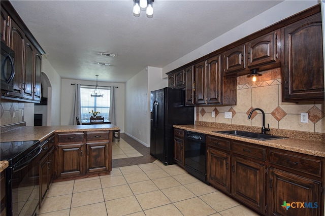 kitchen featuring sink, black appliances, backsplash, dark brown cabinets, and pendant lighting