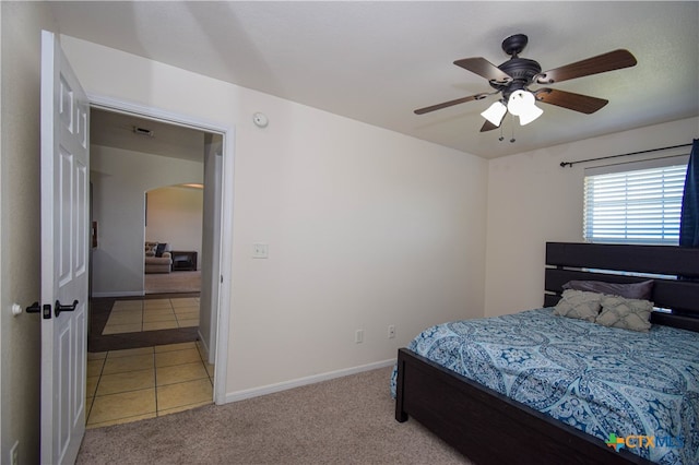 bedroom with light colored carpet and ceiling fan