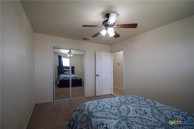 carpeted bedroom with a closet and ceiling fan