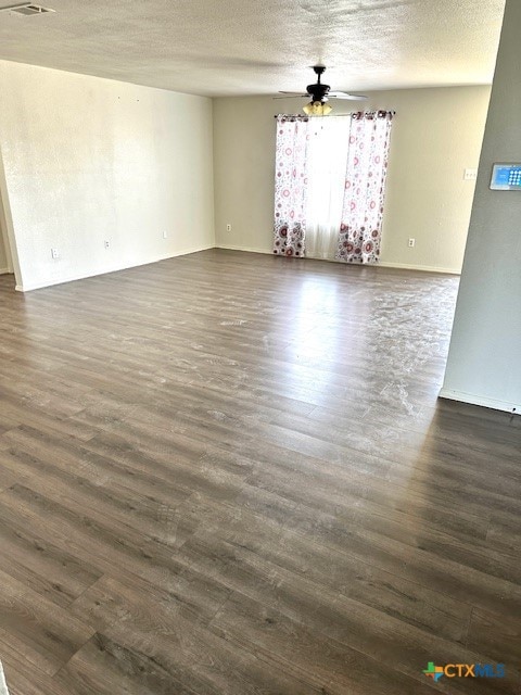 4505 Mustang Dr, Killeen, TX 76549 - interior space featuring a textured ceiling, dark wood-style flooring, visible vents, baseboards, and ceiling fan