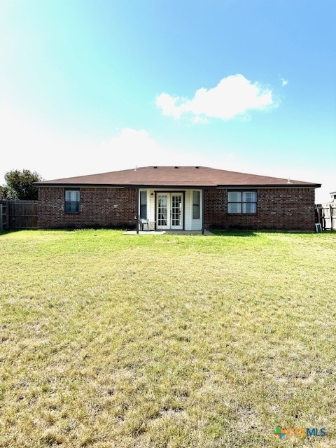 4505 Mustang Dr, Killeen, TX 76549 - back of house with brick siding, french doors, and a lawn