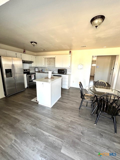 kitchen with white cabinets, dark hardwood / wood-style flooring, and appliances with stainless steel finishes