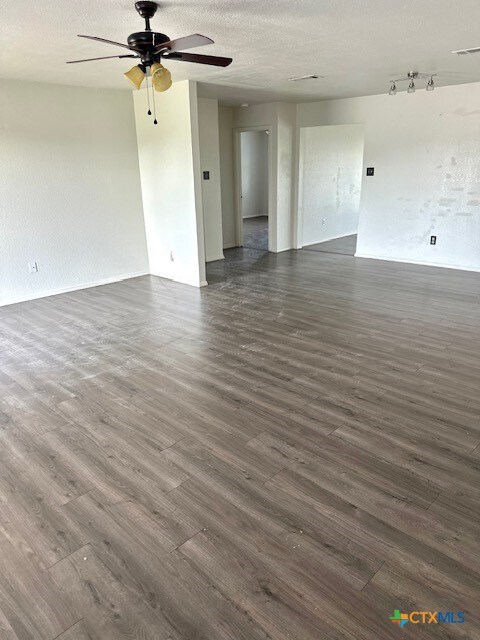 4505 Mustang Dr, Killeen, TX 76549 - empty room with dark wood-style floors, visible vents, baseboards, a textured ceiling, and ceiling fan
