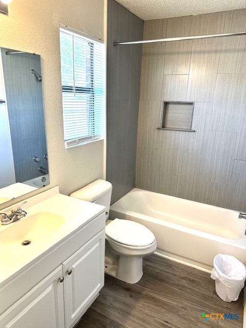 4505 Mustang Dr, Killeen, TX 76549 - bathroom featuring vanity, wood finished floors, shower / tub combination, and toilet