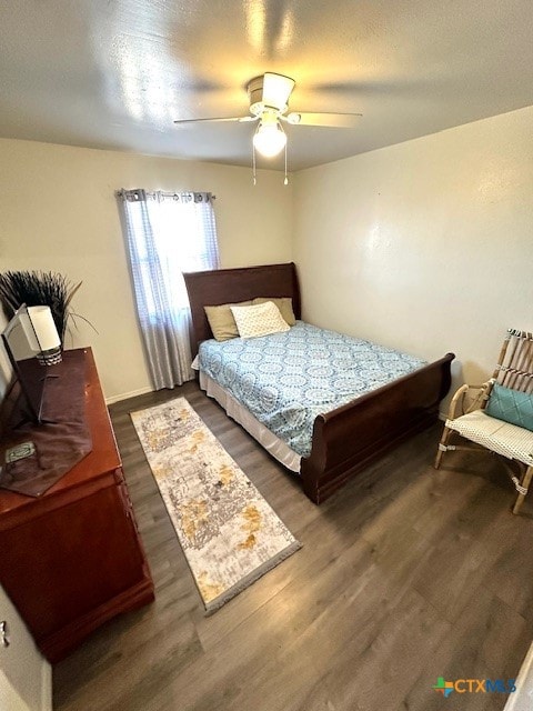 bedroom with ceiling fan and dark hardwood / wood-style floors