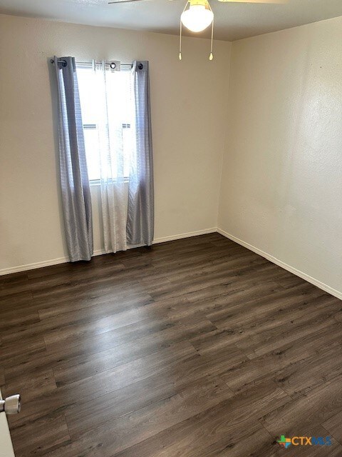 4505 Mustang Dr, Killeen, TX 76549 - unfurnished room with dark wood finished floors and baseboards