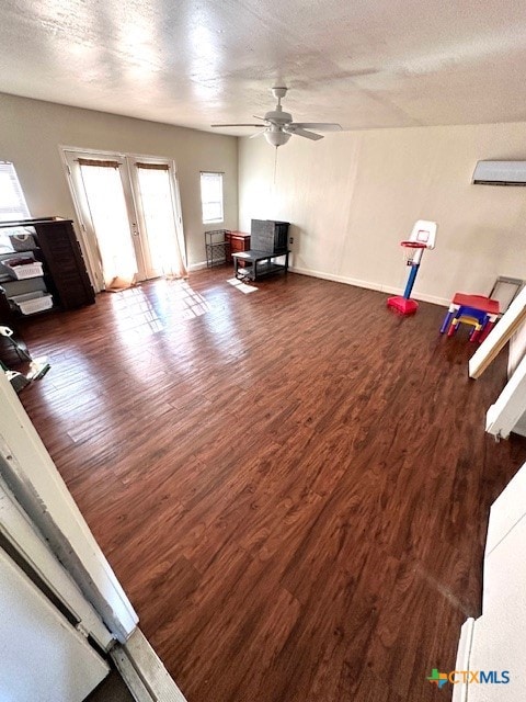 interior space with a textured ceiling, french doors, dark hardwood / wood-style floors, and ceiling fan