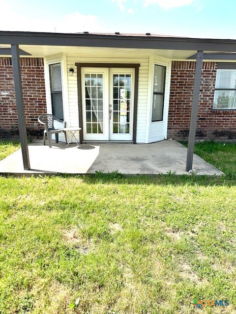 4505 Mustang Dr, Killeen, TX 76549 - back of house with brick siding, a yard, and a patio area
