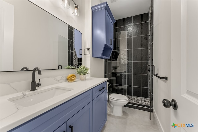 bathroom featuring tile patterned flooring, a shower stall, toilet, and vanity