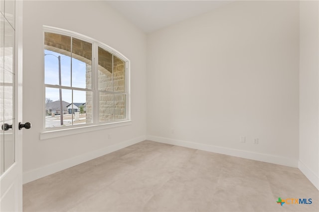 unfurnished room featuring baseboards