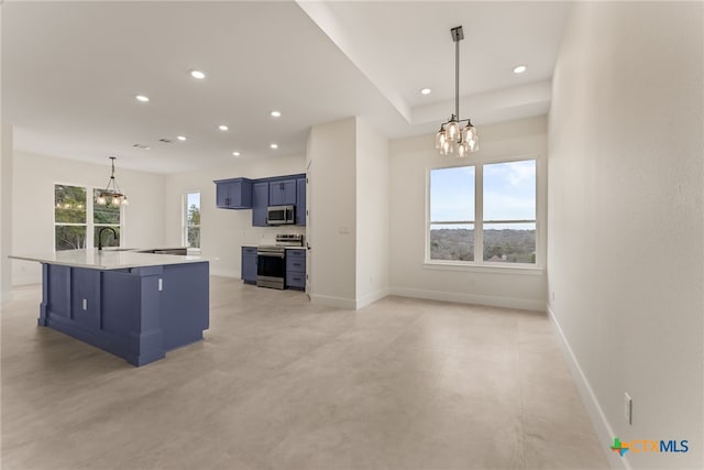 kitchen featuring appliances with stainless steel finishes, blue cabinetry, and an inviting chandelier