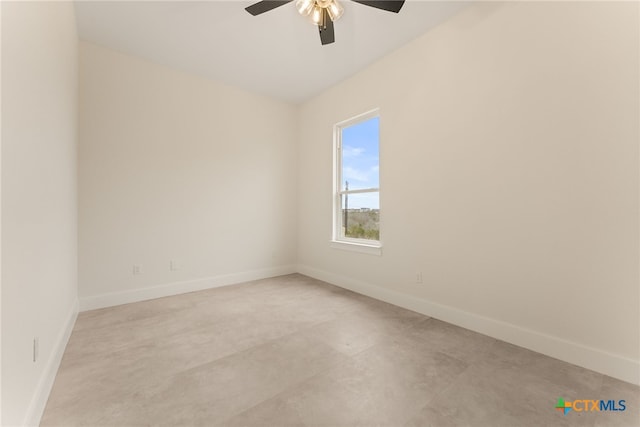 empty room featuring a ceiling fan and baseboards