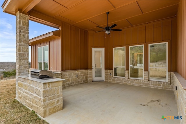 view of patio / terrace featuring a ceiling fan and an outdoor kitchen