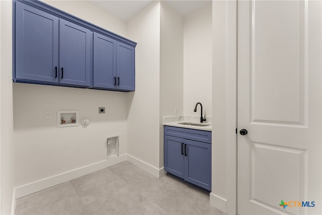 washroom with gas dryer hookup, a sink, baseboards, cabinet space, and electric dryer hookup