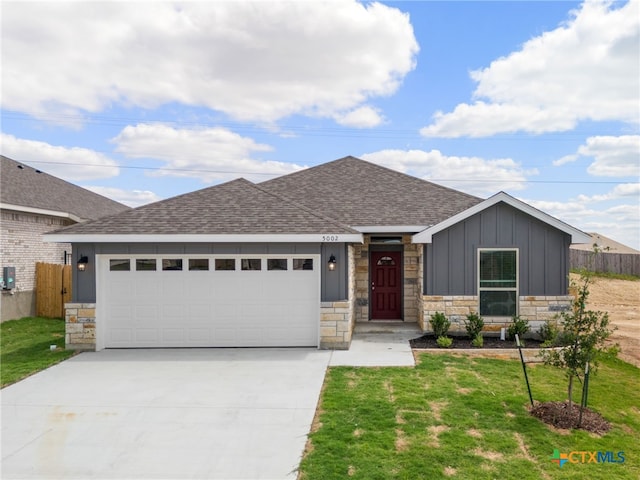 5002 Rose Garden Loop, Killeen, TX 76542 - ranch-style home featuring board and batten siding, driveway, roof with shingles, an attached garage, and stone siding