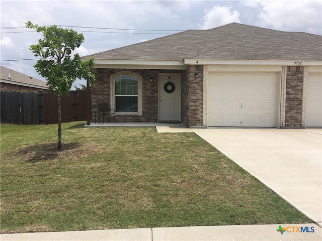 single story home with a front lawn and a garage