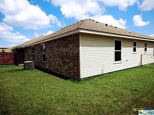 view of property exterior featuring a lawn