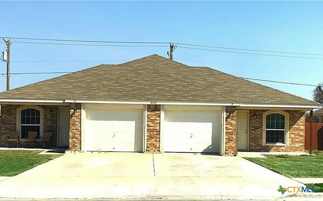 ranch-style house featuring a front lawn and a garage