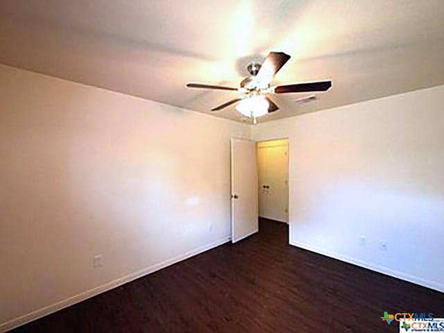 empty room featuring dark hardwood / wood-style flooring