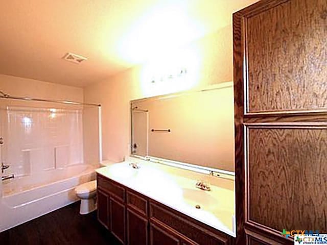 full bathroom featuring vanity, toilet, and bathtub / shower combination