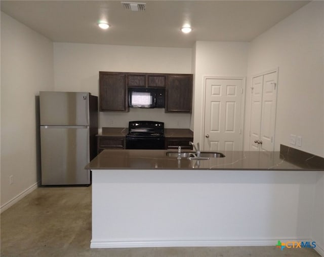 kitchen featuring visible vents, dark brown cabinets, a peninsula, black appliances, and a sink