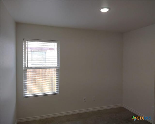 empty room featuring baseboards