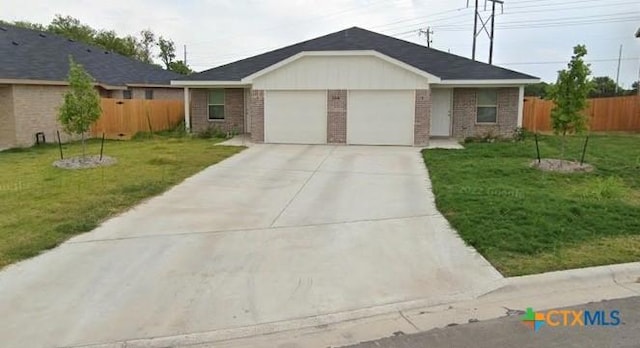 ranch-style home with a garage, brick siding, a front yard, and fence