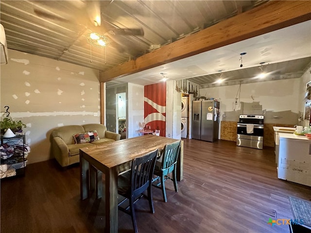 dining area featuring stacked washer / drying machine, dark hardwood / wood-style flooring, and beamed ceiling