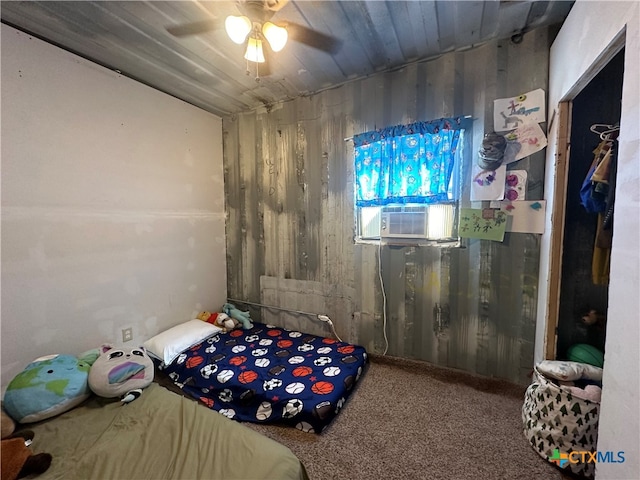 unfurnished bedroom featuring cooling unit, ceiling fan, and carpet floors